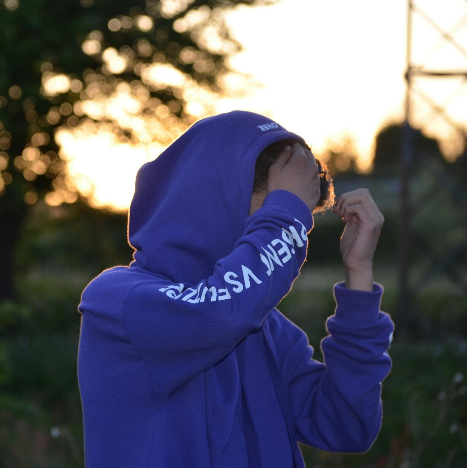 Shallow Focus Photo of Man in Blue Hoodie