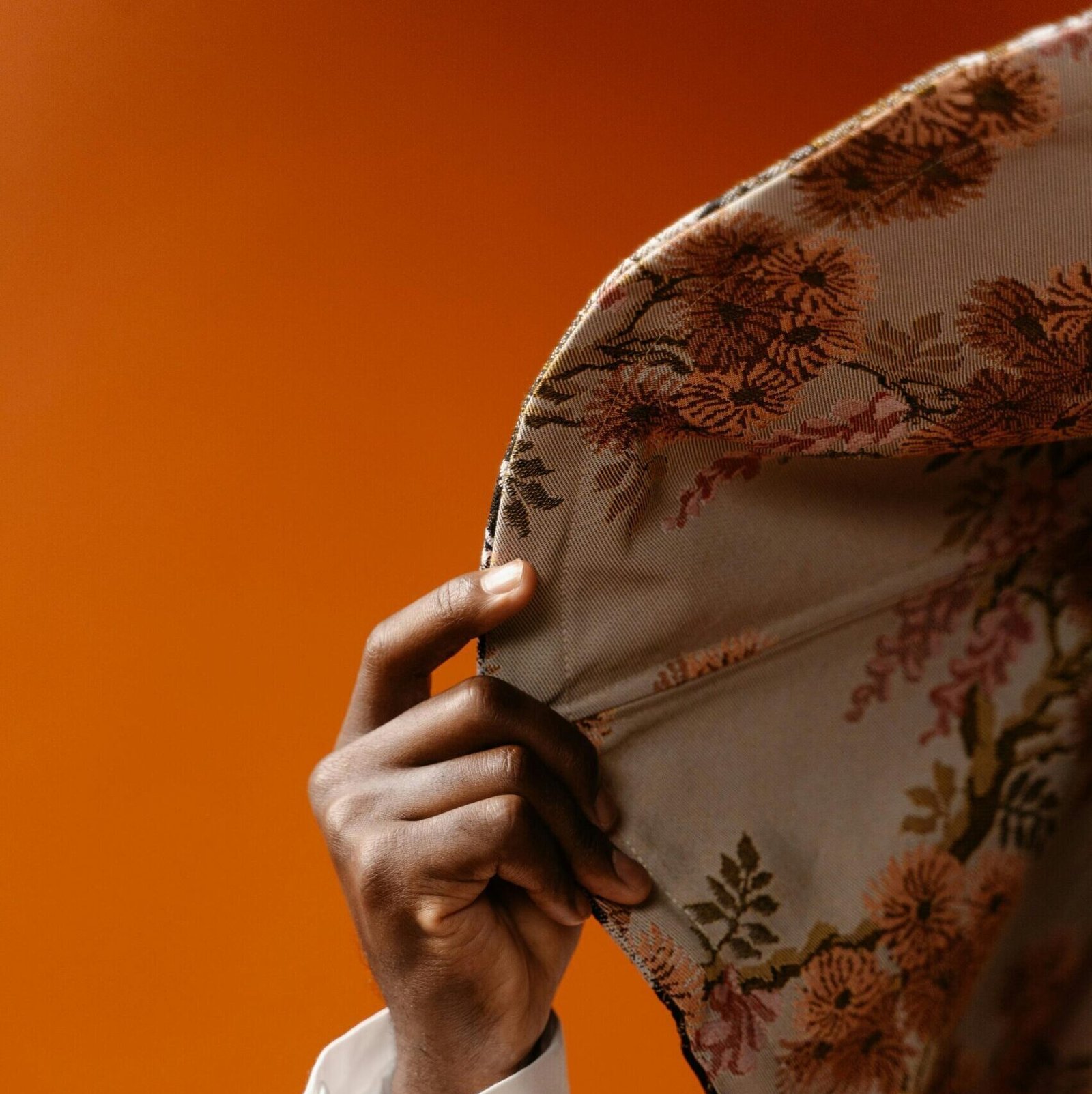 Hand of a Person Holding a Floral Print Textile